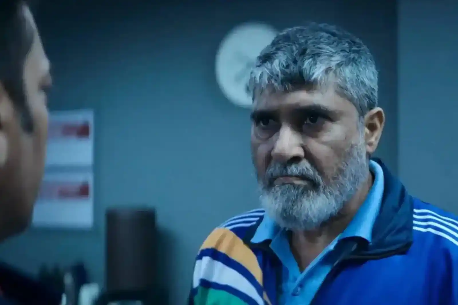 Suvinder Vicky looking stern, weathered, and unyielding in a track jacket
